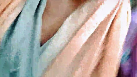 Busty woman teasing with deep cleavage in low-cut blue V-neck top