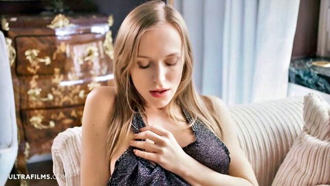 Aislin blonde teen in sparkling black dress, seductive hand on chest pose