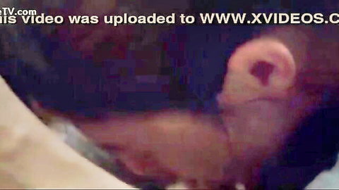 Blurry close-up of dark-skinned neck and ear in intimate adult scene