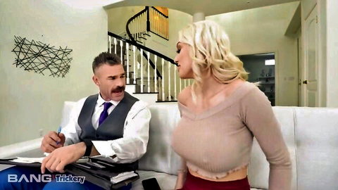 Busty blonde MILF with huge tits in low-cut top teases suited older man on couch