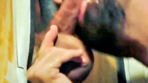 Bearded gay guy sucks huge black cock through glory hole while handjob stroking it
