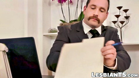 Suited boss with mustache signing contract at office desk