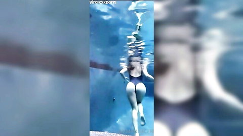 Sexy Latina babe swims underwater revealing juicy ass cheeks in tight black swimsuit