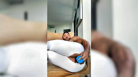 Muscular bearded man teases hole with toy in torn white pants