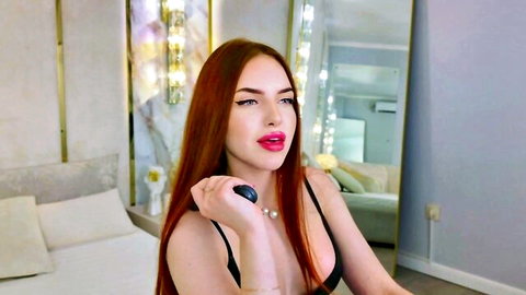 Anje Cox redhead webcam model in black top, seductive pose