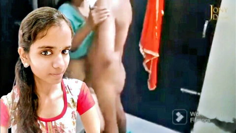 South Asian brunette in pink top watches friend grope naked man's bare ass in bathroom