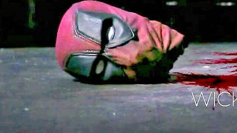 Bloody Deadpool superhero cosplay mask lying in red blood puddle on floor