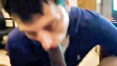 Man in blue shirt deepthroats thick veiny ebony cock in intense gay blowjob.