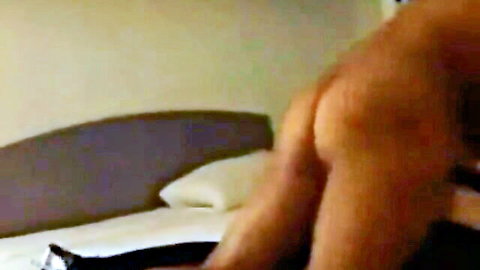 Luxurious crossdresser bent over bed, round ass exposed in explicit scene