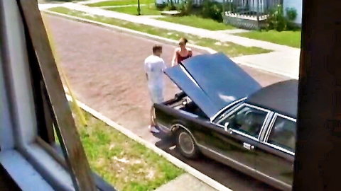 Glamorous hottie Jenny in red top with man by classic car outdoors