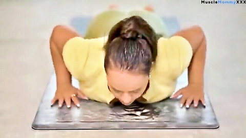 Fit muscle mommy in yellow top doing yoga push-up stretch
