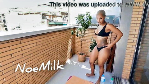 Noe Milk sunbathing in black bikini on terrace, oiled for intense sex