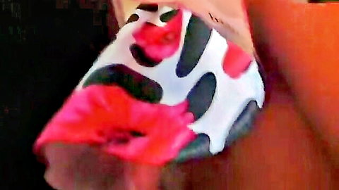 Upskirt view revealing bare pussy in pink floral black-spotted thigh-high stockings