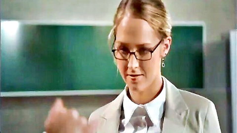 Blonde woman in glasses, suit jacket, white shirt and tie, professional look