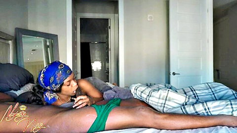 Sexy ebony woman in green panties lounging topless on bed