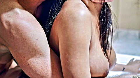 Muscular tanned guy gropes wet brunette's big bare tits from behind in steamy bathroom