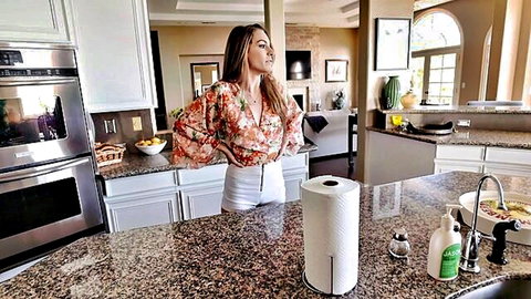 Kimmy Granger in floral blouse and white shorts posing seductively