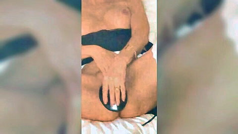 Swedish MILF nude in bed, hand on pussy with sex toy