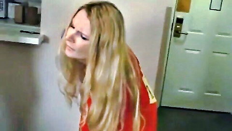 Blonde superhero Savannah Costello in red costume pose