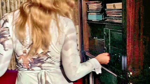 Vintage blonde in sheer floral dress opening drawer solo
