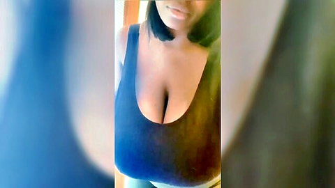 Ebony beauty with massive cleavage in tight black tank top selfie