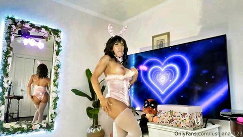 Fit muscular babe in pink bunny lingerie teasing huge tits and toned ass in bedroom mirror
