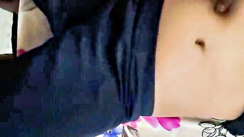 Sexy Indian woman exposing her pierced navel and toned midriff in blue blouse and pink petticoat