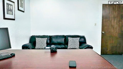 Empty Backroom Casting Couch room with black leather sofa and desk ready for amateur pussy auditions