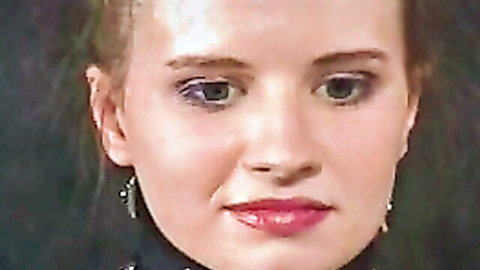 Seductive blonde woman with green eyes and red lips close-up