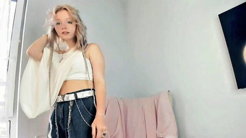 Hanaszot young blonde amateur in crop top and chain pants posing shyly
