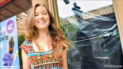 Brielle from FTV Girls smiling in low-cut colorful dress showing cleavage outdoors