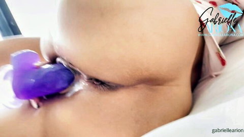 Gabrielle Ariona eye close-up with purple heart-shaped toy