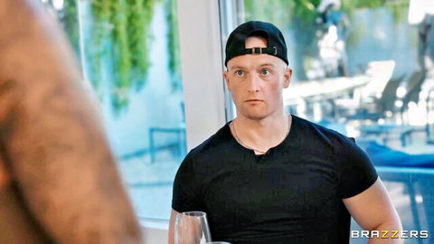 Muscular man in black t-shirt and cap in tense Brazzers chef scene