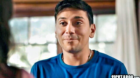 Handsome smirking Latino DILF in blue t-shirt smiling seductively indoors
