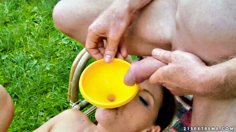 Agata drinks piss from funnel in outdoor golden shower with man