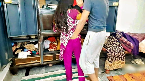 Desi Indian woman in pink salwar kameez hugged intimately by man from behind