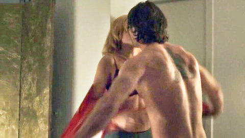 Sally Golan in passionate kiss with shirtless tattooed man in lingerie