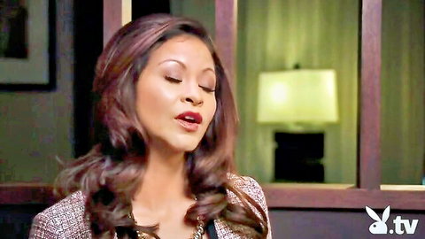 Seductive mixed-race brunette in gray tweed outfit on Playboy TV swing episode