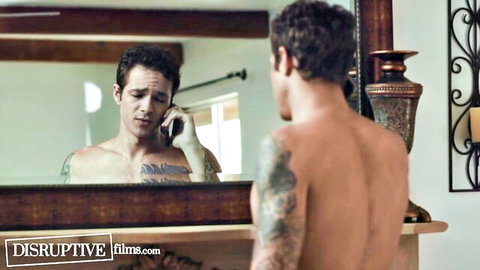 Shirtless tattooed muscular hunk talking on phone in ornate mirror reflection