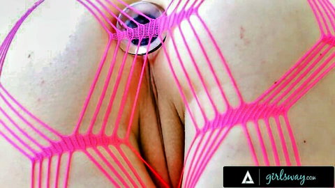 Skinny babe's hairy pussy and jeweled butt plug in ass framed by pink fishnet lingerie