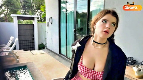SkinLovers model in low-cut red checkered top and black jacket, showing deep cleavage outdoors