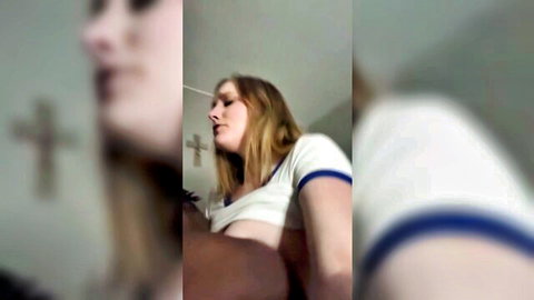 Blonde girl in white crop top moaning in pleasure with black partner's hand on her