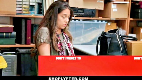 Brunette caught shoplifting in store, tense expression