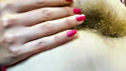 Close-up of 18-year-old girl's tight wet hairy pussy with red-nailed hand