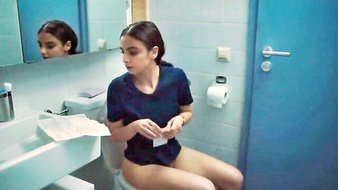 Brunette babe sitting bottomless on toilet exposing pussy in bathroom mirror view