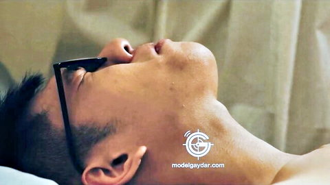 Seductive Asian hunk with glasses lying back shirtless