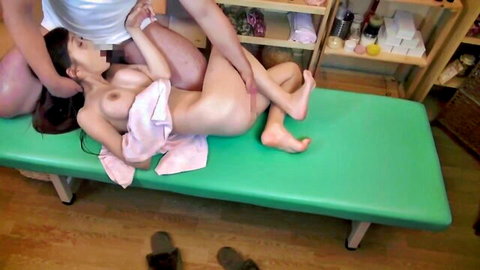 Petite Japanese babe with hairy pussy spread wide as hairy man roughly gropes her nude body on massage table