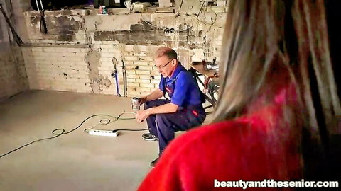 Teenager Anina in red top with elder John in blue shirt intimate moment