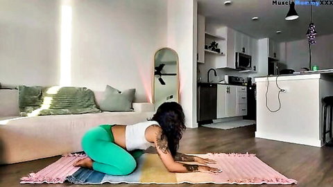 Fit Black woman in green leggings doing yoga pose, emphasizing curves
