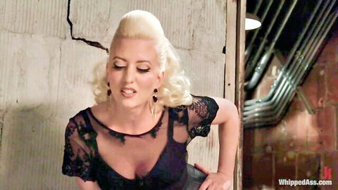 Blonde bombshell in sheer black lace top poses for rough BDSM punishment